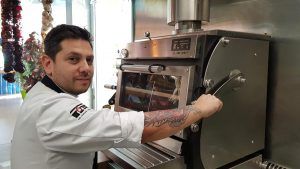Diego Gallegos with the Pira 70ED charcoal oven.